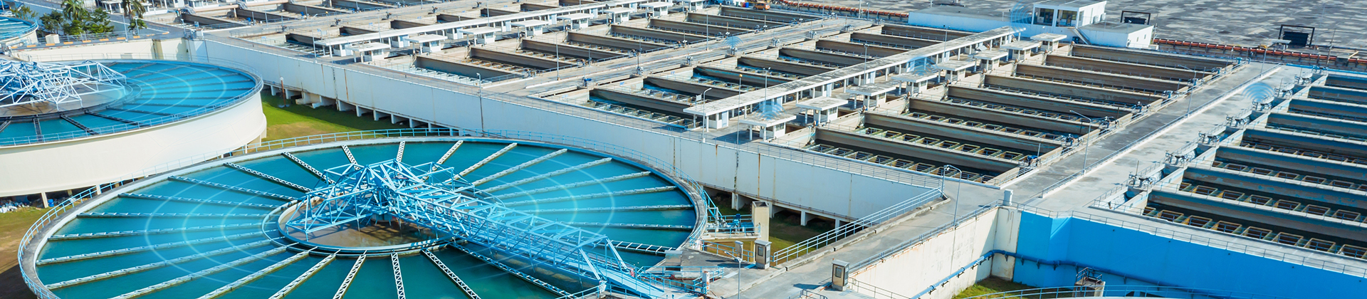 Aerial view of a wastewater plant, with blue lights indicating condition monitoring sensors